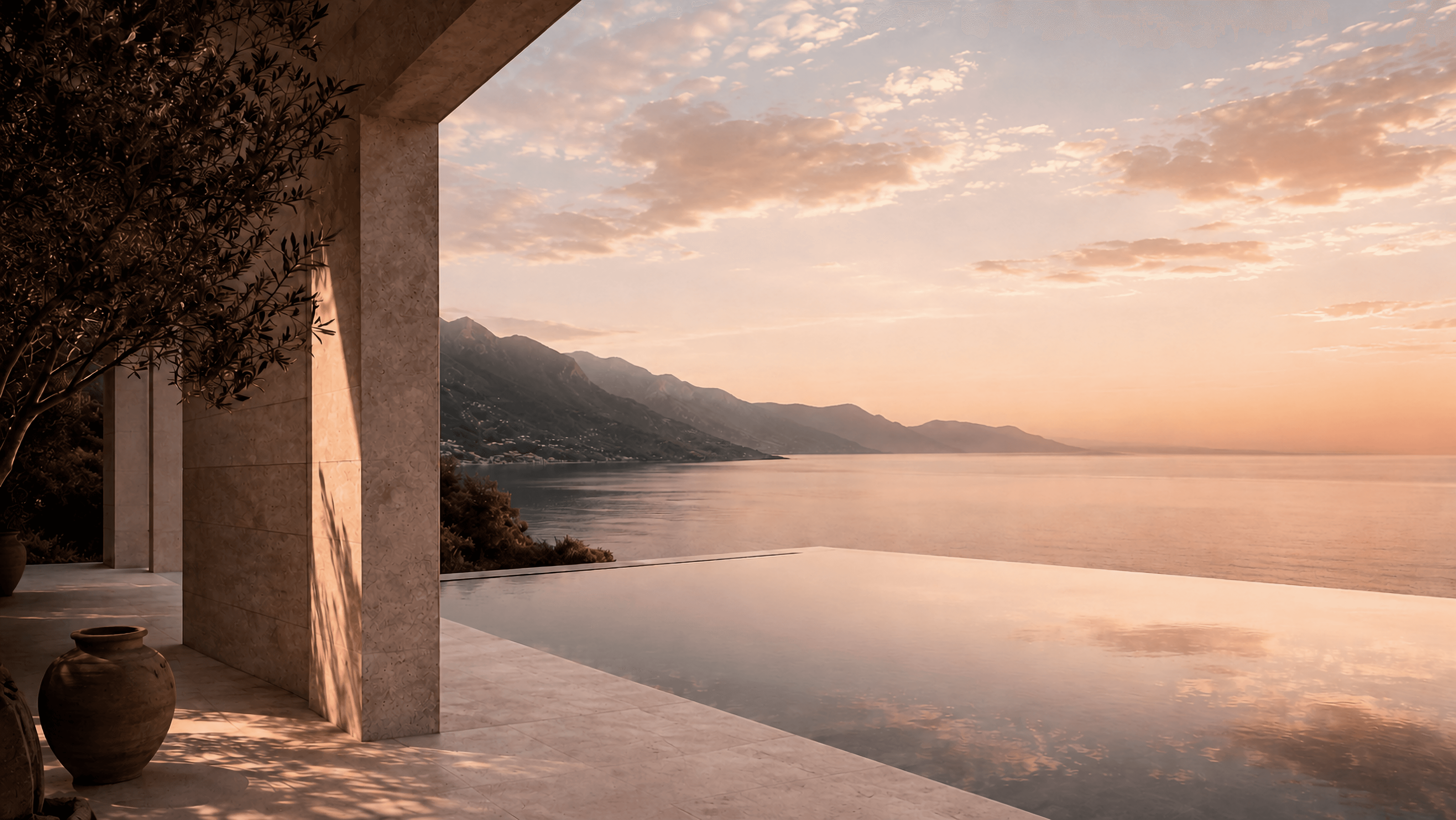 Sunset over a coastal architectural terrace and infinity pool