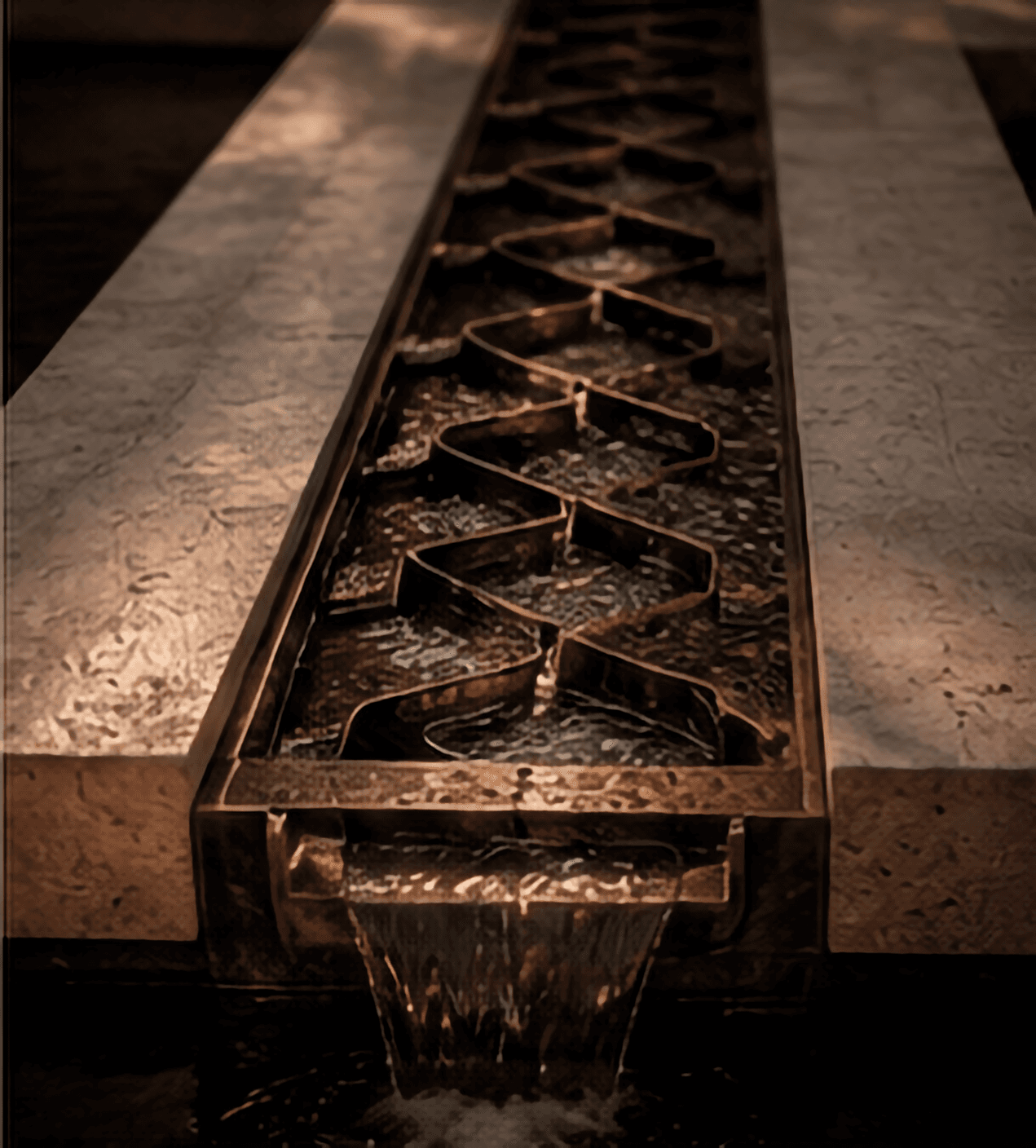 Bronze water channel detail set within limestone at Sighthound Sanctuary.